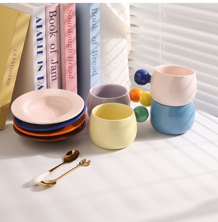 Coffee cups and saucers with contrasting colors and round handles