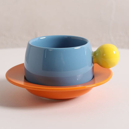 Coffee cups and saucers with contrasting colors and round handles