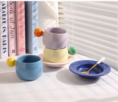 Coffee cups and saucers with contrasting colors and round handles